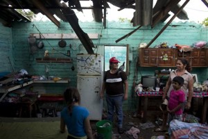 Josefina Magana Ruiz, center, surveys her home damaged by Hurricane Patricia, in La Fortuna, Mexico. Hurricane winds tore off much of the roof of the two-room home where seven people live, soaking mattresses and destroying belongings. Record-breaking Patricia pushed rapidly inland over mountainous western Mexico early Saturday, weakening to tropical storm force while dumping torrential rains that authorities warned could cause deadly floods and mudslides, La Fortuna, Mexico, Oct. 24, 2015 | AP Photo/Rebecca Blackwell, St. George News