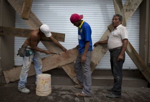 Men nail boards across the shutters of a waterfront business, as residents prepare for the arrival of Hurricane Patricia in Puerto Vallarta, Mexico. Patricia barreled toward southwestern Mexico Friday as a monster Category 5 storm, the strongest ever in the Western Hemisphere. Locals and tourists were either hunkering down or trying to make last-minute escapes ahead of what forecasters called a "potentially catastrophic landfall" later in the day, Puerto Vallarta, Mexico, Oct. 23, 2015 | AP Photo/Rebecca Blackwell, St. George News