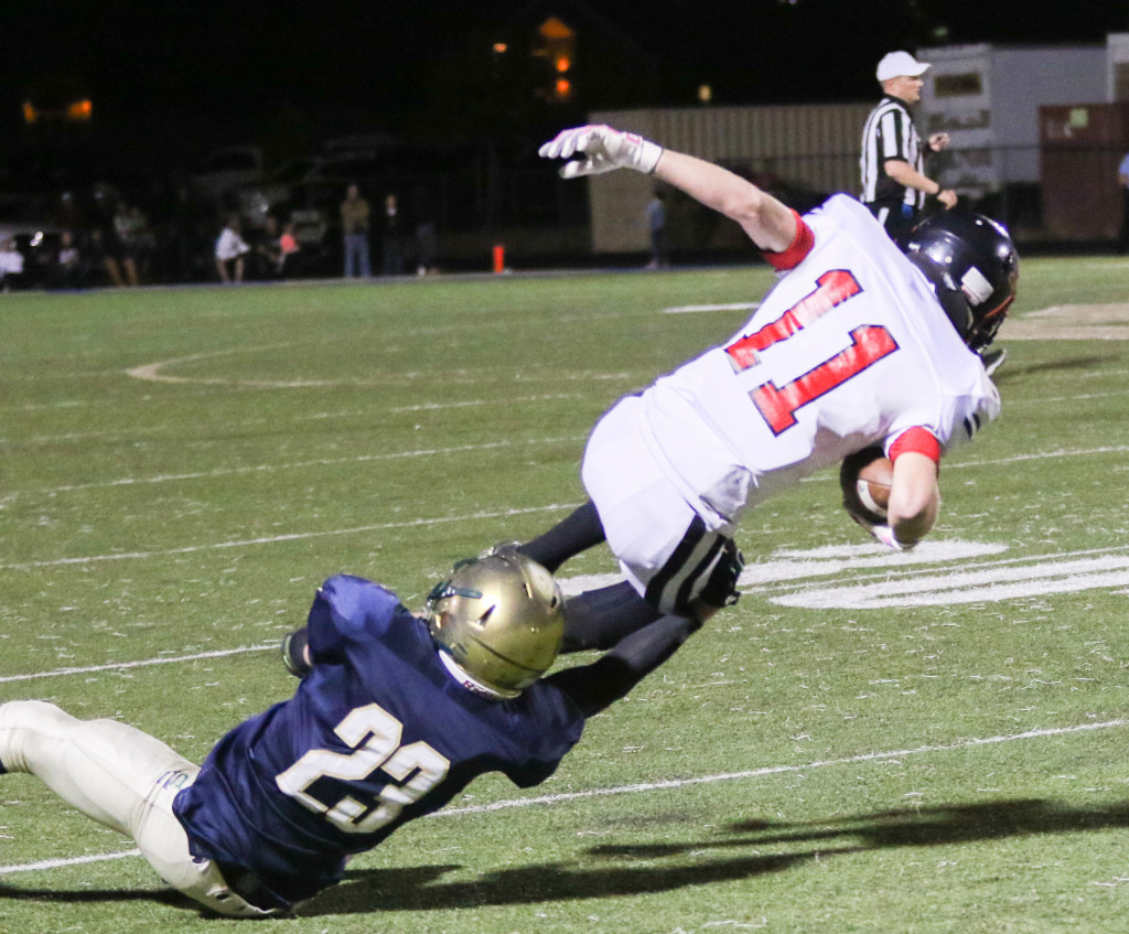 Hurricane and Snow Canyon both play first round games this Friday. File photo of Snow Canyon's Teagan Mendenhall (23) and Hurricane 's Lucas Stout, Snow Canyon vs Hurricane, Football, St George, Utah, Oct. 23, 2015, | Photo by Kevin Luthy, St. George News