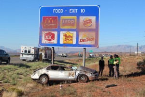A passenger car came to rest against a highway sign after being forced off the road Wednesday morning, Washington, Utah, October 7, 2015 | Photo by Ric Wayman, St. George News