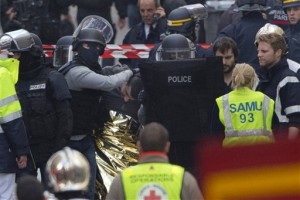 Hooded police officers detain a man in Saint-Denis, near Paris, A woman wearing an explosive suicide vest blew herself up Wednesday as heavily armed police tried to storm a suburban Paris apartment where the suspected mastermind of last week's attacks was believed to be holed up, police said, Saint-Denis, France, Nov. 18, 2015 | Photo by /Peter Dejong (AP), St. George News