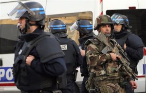 Police forces and soldiers patrol in Saint-Denis, a northern suburb of Paris. Police say two suspects in last week's Paris attacks, a man and a woman, have been killed in a police operation north of the capital. Two police officers have been injured in the standoff. Police have said the operation is targeting the suspected mastermind of last week's attacks, believed to be holed up in an apartment in Saint-Denis with several other heavily armed suspects, Saint-Denis, France, Nov. 18, 2015 | Photo by Christophe Ena (AP), St. George News