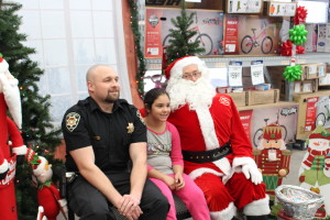 A police officer and a child pose with Santa at the annual Shop with a Cop event, Cedar City, Utah, Dec. 12, 2015 | Photo by Emily Hammer, Cedar City News 