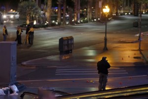 A crime scene analyst, right, takes photos as Las Vegas Metro Police and Nevada Highway Patrol troopers investigate an incident where police said a woman intentionally swerved her car into pedestrians on the Las Vegas Strip, killing one person and injuring at least 30 others. Las Vegas, Nevada, Dec. 20, 2015. | Photo by Steve Marcus, Las Vegas Sun via AP, St. George News