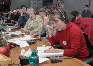 Jennifer Eckels, first time NORAD Tracks Santa volunteer, takes calls at the NORAD Tracks Santa Operations Center. One of the calls Eckels received was from a little boy in Missouri who recently lost his sister. He wanted to know when Santa delivers presents to Heaven. Eckels told him that children in Heaven get their presents first, Peterson Air Force Base, Colorado, Dec. 24, 2012 | Photo by Technical Sgt. Michael Kucharek, United States Air Force, St. George News