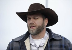 Ammon Bundy, one of the sons of Nevada rancher Cliven Bundy, speaks with reporters during a news conference at Malheur National Wildlife Refuge headquarters Monday, Jan. 4, 2016, near Burns, Ore. The group calls itself Citizens for Constitutional Freedom and has sent a "demand for redress" to local, state and federal officials. Armed protesters took over the Malheur National Wildlife Refuge on Saturday after participating in a peaceful rally over the prison sentences of local ranchers Dwight and Steven Hammond, Malheur National Wildlife Refuge, Oregon, Jan. 4, 2016 | AP Photo/Rick Bowmer, St. Goerge News