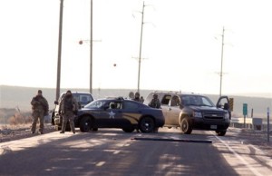 Police officers block the turnout to Sodhouse Lane, which is the main road leading to the Malheur National Wildlife Refuge headquarters, Wednesday, Jan. 27, 2016, near Burns, Ore. Authorities were restricting access on Wednesday to the Oregon refuge being occupied by an armed group after one of the occupiers was killed during a traffic stop and eight more, including the group's leader Ammon Bundy, were arrested, near Burns, Oregon, Jan. 27, 2916 | Photo by Beth Nakamura/The Oregonian via AP, St. George News,