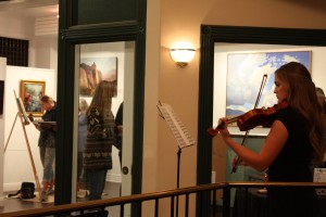 Artist Aimee Bonham paints in the background during an Art on Main gallery stroll, St. George, Utah, November, 2015 | Photo courtesy of "Arts to Zion," St. George News