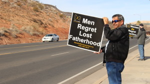 A demonstrator holds a sign in opposition to abortion during a protest at the St. George offices of Planned Parenthood in St. George, Utah on Jan. 22, 2016. | Photo by Leanna Bergeron, St. George News