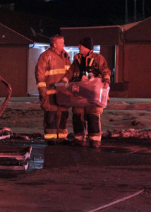 Firefighters help carry out bins with residents belongings in them, 100 W. 200 South area, Cedar City, Utah, Jan. 6, 2016 | Photo by Carin Miller, St. George News