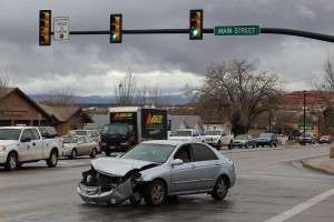 A car sits damaged in an intersection after running a red light and striking another car, Washington, Utah, January 6, 2016 | Photo by Ric Wayman, St. George News