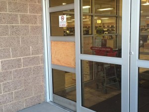 Wood covers where a pane of glass was broken out Friday morning to gain access to the State Liquor Store, St. George, Utah, Jan. 1, 2016 | Photo by Mori Kessler, St. George News