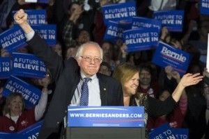 Democratic presidential candidate, Sen. Bernie Sanders, I-Vt, and his wave Jane acknowledge the crowd as he arrives for his caucus night rally, Des Moines, Iowa, Monday, Feb. 2, 2016 | AP Photo by Patrick Semansky