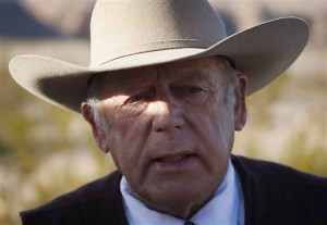 In this file photo, rancher Cliven Bundy stands along the road near his ranch. Bundy, the father of the jailed leader of the Oregon refuge occupation, and who was the center of a standoff with federal officials in Nevada in 2014, was arrested in Portland on Wednesday, the FBI said. Bunkerville, Nevada, Jan. 27, 2016 | File Photo by John Locher (AP), St. George News