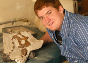 Kevin Terris, with the skull of the baby Parasaurolophus nicknamed “Joe” that he discovered | Courtesy of the Raymond M. Alf Museum of Paleontology, St. George News