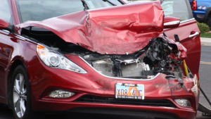 Damage to the front end of a red Hyundai on Bluff Street. Mar. 5, 2016 | Photo by Don Gilman, St. George News