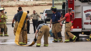 Firefighters from Hurricane Valley Fire and Rescue, Washington Fire Department and St. George Fire Department gather outside the Purgatory Correctional Facility in Hurricane after a fire started in a drier at the jail. Mar. 11, 2016 | Photo by Don Gilman, St. George News.