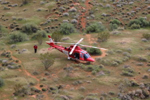 A Life Flight helicopter waits in a grassy spot a short distance from where a climber fell on a rappel from the Cougar Cliffs in St. George, Utah, Mar. 12, 2016 | Photo by Don Gilman, St. George News