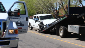A GMC pickup truck is loaded onto a tow truck after a collision occurred at the 1150 block of West Red Hills Parkway in Washington City, Utah, March 23, 2016 | Photo by Don Gilman, St. George News