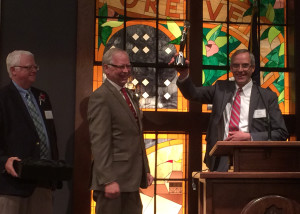 Founders Citation recipients Jon Smith and Lee Byers honor University President Scott L. Wyatt with an AVA Digital Award for his role as executive producer in "Back up the Mountain," Southern Utah University Gilbert Great Hall, Cedar City, Utah, March 23, 2016 | Photo by Carin Miller, St. George News