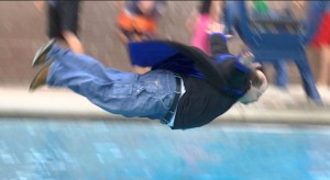 St. George News senior reporter Mori Kessler flies through the air on his way to a perfect belly flop Saturday in this year's Special Olympics Polar Plunge. St. George, Utah, March 5, 2016 | Photo by Sheldon Demke, St. George News