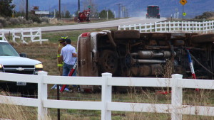 Emergency responders with the Dodge pickup track that rolled off state Route 18 Saturday morning. The driver and sole occupant of the truck, a 78-year-old Ivins man, died at the scene. Enterprise, Utah, April 9, 2016 | Photo by Don Gilman, St. George News