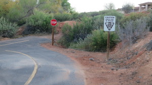 A sign with yield guidelines and a stop sign for trail users on the Snow Canyon Trail near Bluff Street, April 11, 2016. Multi-use trails along major roads often cross driveways or side streets, and thus have stop signs. Riding on the road allows cyclists to ride through and in a way that is more predictable for motorists. St. George, Utah, April 13, 2016 | Photo by Tim Tabor, St. George News 