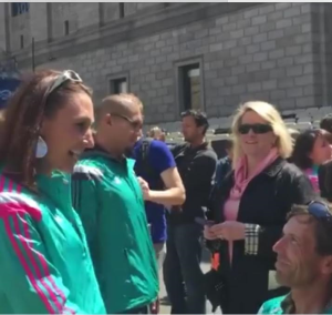 Screenshot from video. L-R Bethany Clevenger Ericksen is proposed to by Walter Brown at the site of the finish line of the Boston Marathon, Boston, Massachusetts, April 17, 2016 | Image courtesy of Walter Brown