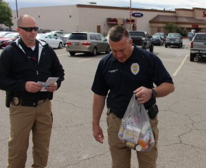 St. George Police detectives accept a bag of unused prescription drugs at the semi-annual Drug Take-Back Day, St. George, Utah, April 30, 2016 | Photo by Ric Wayman, St. George News