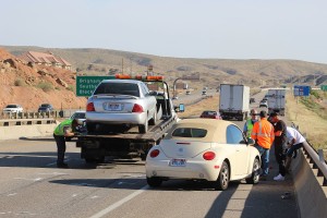 A Nissan Sentra is towed from the freeway after hitting a motorcycle rider from behind Tuesday. St. George, Utah, April 5, 2016 | Photo by Ric Wayman, St. George News