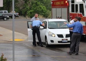 St. George Police officer Jeremy Needles gives a thumbs up to an 8-year-old boy after he had been struck by a car exiting the parking lot at Heritage Elementary School, St. George, Utah, April 27, 2016 | Photo by Ric Wayman, St. George News