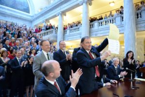 Gov. Gary Herbert displays Senate Bill 296 after signing it into state law, Salt Lake City, Utah, March 12, 2015 | Photo by Intellectual Reserve, Inc., courtesy of The Church of Jesus Christ of Latter-day Saints, St. George News