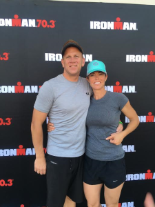 L-R Heath Snow and Tara Snow pose together in front of and Ironman 70.3 backdrop. Location and date not specified | Photo courtesy of Tara Snow, St. George News