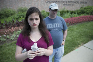 Bettina Ernsg, of Cincinnati, holds a candle alongside her father John, right, during a vigil outside the Cincinnati Zoo & Botanical Garden, Monday, May 30, 2016, in Cincinnati. Animal rights activists gathered Monday for a Memorial Day vigil for Harambe, the gorilla killed at the Cincinnati Zoo on Saturday after a 4-year-old boy slipped into an exhibit and a special zoo response team concluded his life was in danger. Cincinnati, Ohio, May 30, 2016 | Photo by John Minchillo (AP), St. George News