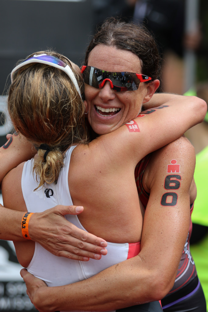 Women's pro winner Heather Wurtele (60) hugs second-place finisher Holly lawrence, Ironman 70.3, St. George, Utah, May 7, 2016, | Photo by Kevin Luthy, St. George News