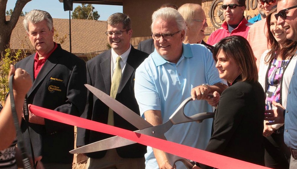 File photo - Darcy Stewart (blue shirt) helps cut the ribbon marking the reopening of the Bloomington Country Clubhouse. The building's renovations are a part of the ongoing effort to revitalise the Bloomington Country Club and golf course, St. George, Utah, March 31, 2016 | Photo by Don Gilman, St. George News