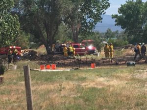 A fire Sunday afternoon melted the siding on one home and threatened others, Enoch, Utah, June 5, 2016 | Photo by Tracie Sullivan, St. George News