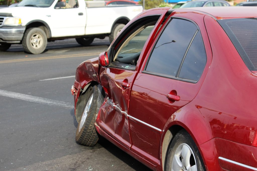 A red Volkswagon Jetta sustained extensive driver's side damage after a two-car collision at the intersection of Green Springs Drive and Red Cliffs Drive, Washington City, Utah, June 10, 2016 | Photo by Cody Blowers, St. George News