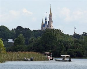 In the shadow of the Magic Kingdom Florida Fish and Wildlife Conservation Officers search for the body of a young boy Wednesday after the boy was snatched off the shore and dragged underwater by an alligator Tuesday night at Grand Floridian Resort at Disney World, Lake Buena Vista, Florida, June 15, 2016 | Photo by Red Huber/Orlando Sentinel (AP), St. George News