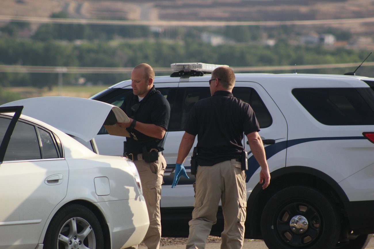 Police officers going through a car used by two suspecta in an armed robbery of the Hurricane Family Pharmacy, Hurricane, Utah, June 21, 2016 | Photo by Mori Kessler, St. George News