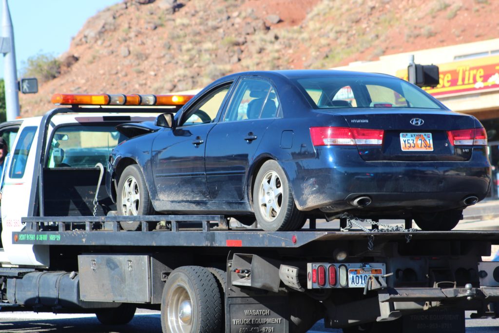 Dark blue Hyundai is towed after accident on Red Cliffs Drive, St. George, Utah, June 16, 2016 |Photo by Cody Blowers, St. George News