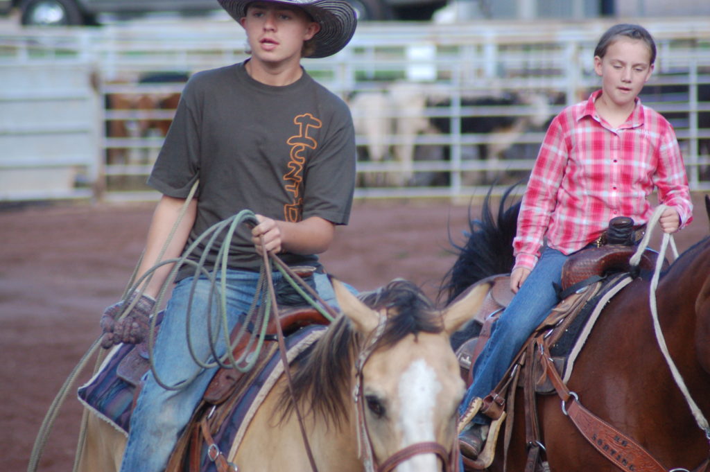 Young cowboys ride around the arena before the start of the Gunlock Rodeo, Gunlock, Utah, July 1, 2016 | Photo by Hollie Reina, St. George News