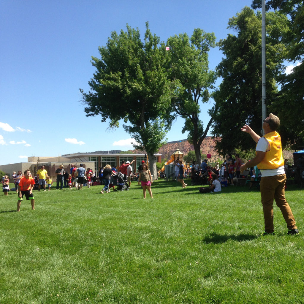 Joe Godwin of the Cedar City Lions plays a water balloon toss with kids in the Main Street Park, Cedar City, Utah, July 4, 2016 | Photo by Paul Dail, Cedar City News