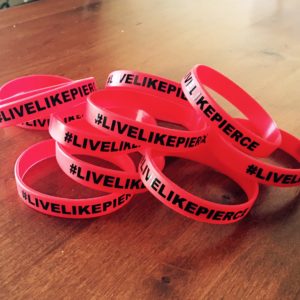 These wrist bands, bearing the hashtag #livelikepierce, have been sold as part of a fundraiser to help his family, date unspecified | photo courtesy of Amy Barney