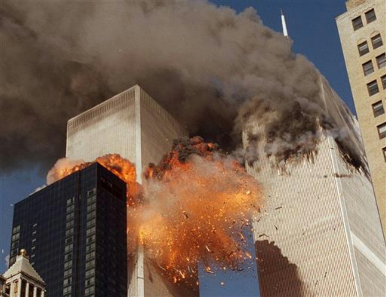 File photo, smoke billows from World Trade Center Tower 1 and flames explode from Tower 2 as it is struck by American Airlines Flight 175, in New York. The government is preparing to release a once-classified chapter of a congressional report about the attacks of Sept. 11, that questions whether Saudi nationals who helped the hijackers with things like finding apartments and opening bank accounts knew what they were planning. House Minority Leader Nancy Pelosi said Friday July 15, 2016, that the release of the 28-page chapter is "imminent.” File photo from New York City, New New York, Sept. 11, 2001 | AP File Photo by Chao Soi Cheong, St. George News