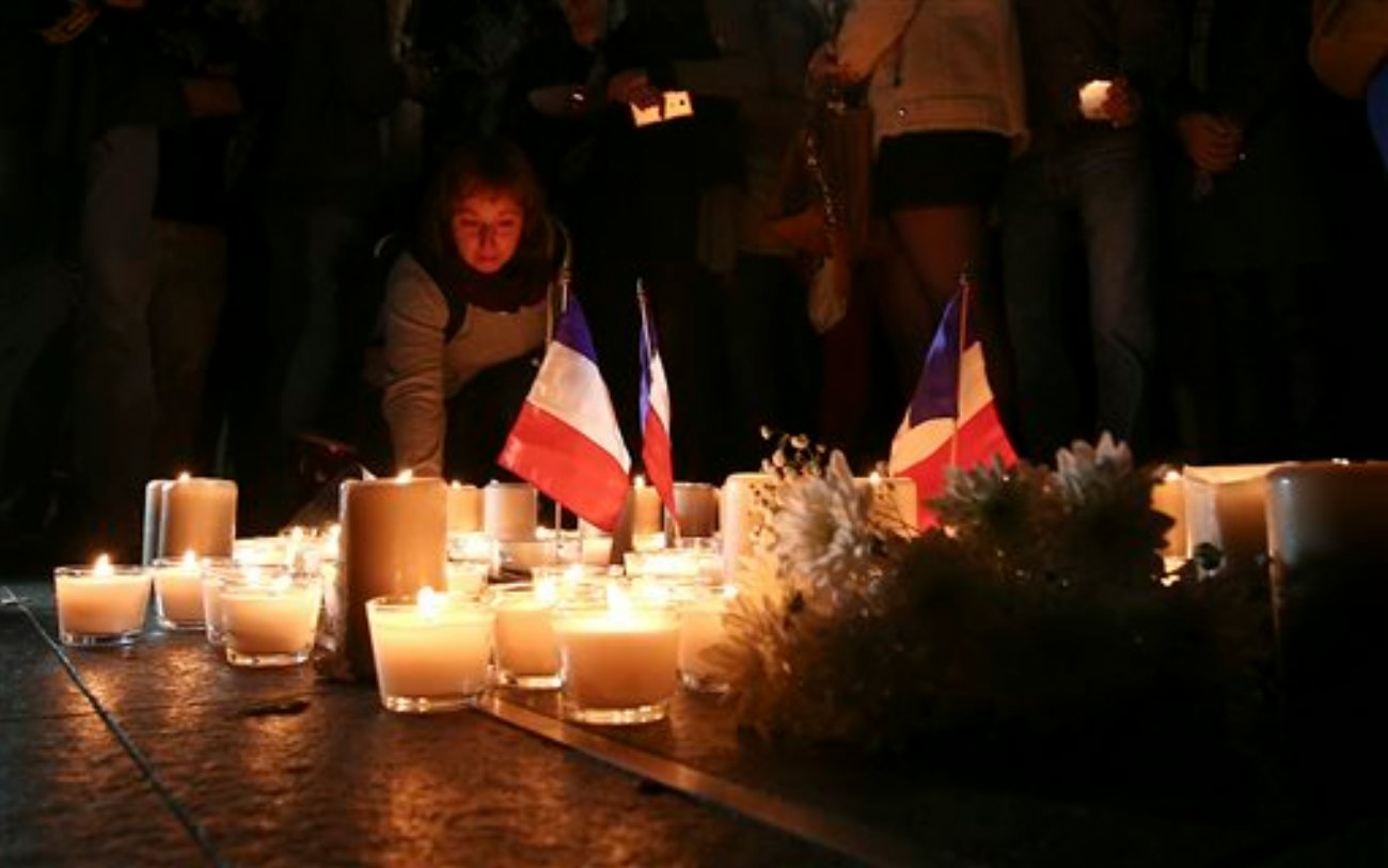 A woman places a candle during a vigil to honor victims of the Bastille Day tragedy in Nice, France, in Sydney, Australia. World leaders are expressing dismay, sadness and solidarity with France over the attack carried out by a man who drove truck into crowds of people celebrating France's national day in Nice, Sydney, Australia, July 15, 2016 | AP Photo by Rob Griffith. St. George News