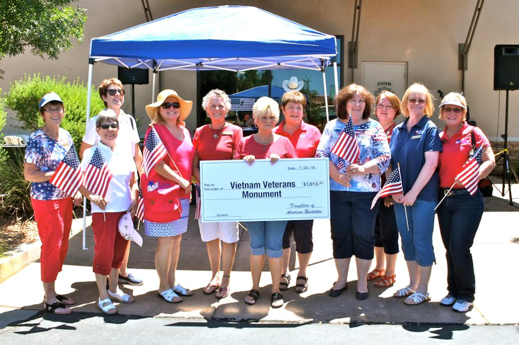 Members of the Daughters of the American Revolution Color Country Chapter present a check to Judith Cooley (center holding the check) and the Vietnam Veterans Monument at a fundraiser for the monument held at Zion Harley Davidson, Washington City, Utah, July 23, 2016 | Photo courtesy of Valerie King, St. George News