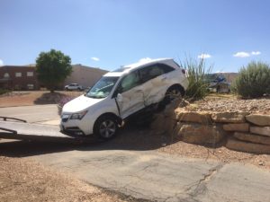 White Dodge SUV involved in two-car collision after driver runs stop sign on River Road and Commerce Drive, Aug. 11, 2016 | Photo by Cody Blowers, St. George News