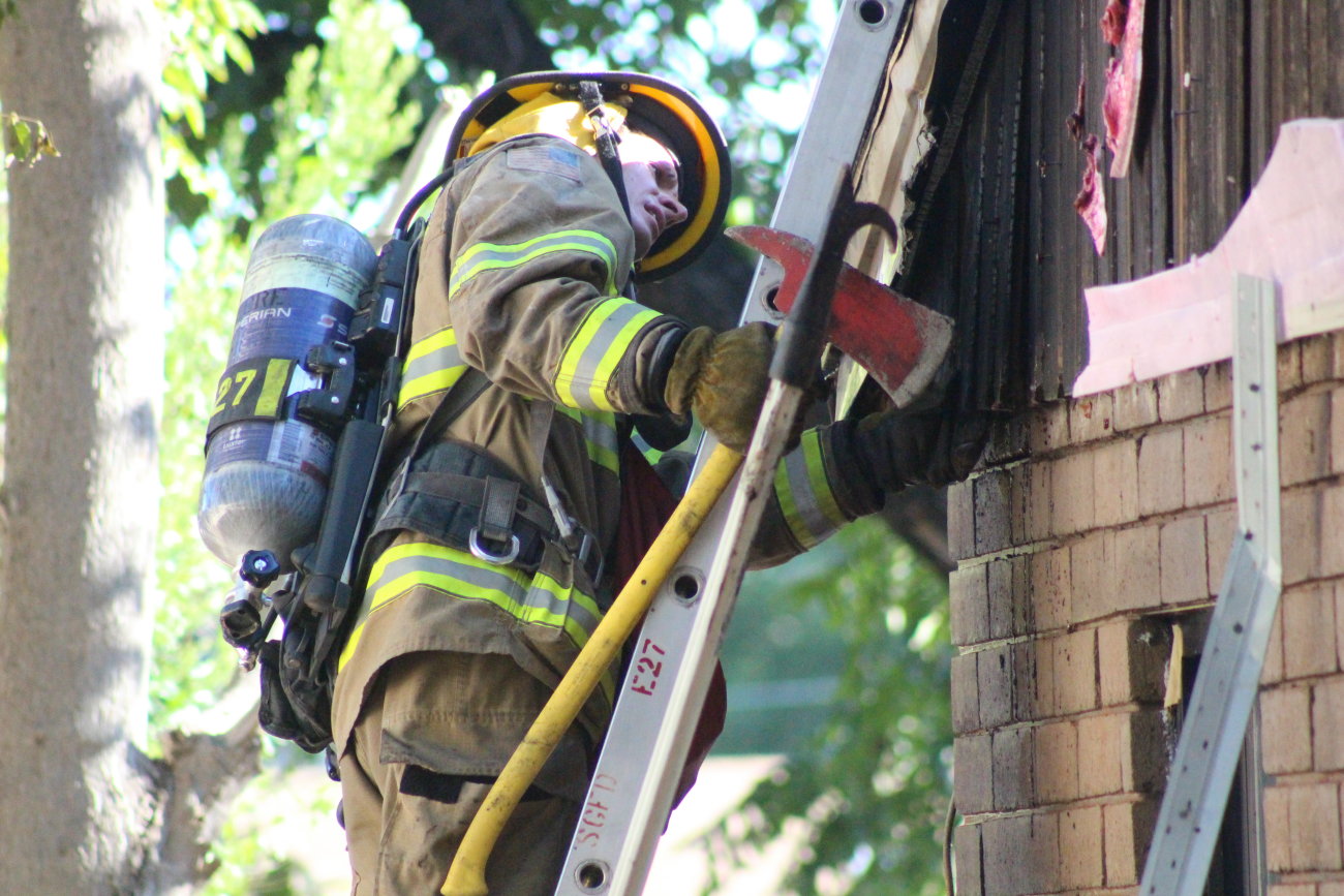 An outdoor fire scorched the side of a home on 600 North. charring brick and melting siding before it was extinguished, firefighters investigated the attic area to make sure the sure hadn't slipped into that part of the home, St. George, Utah, Aug. 16, 2016 | Photo by Mori Kessler, St. George News