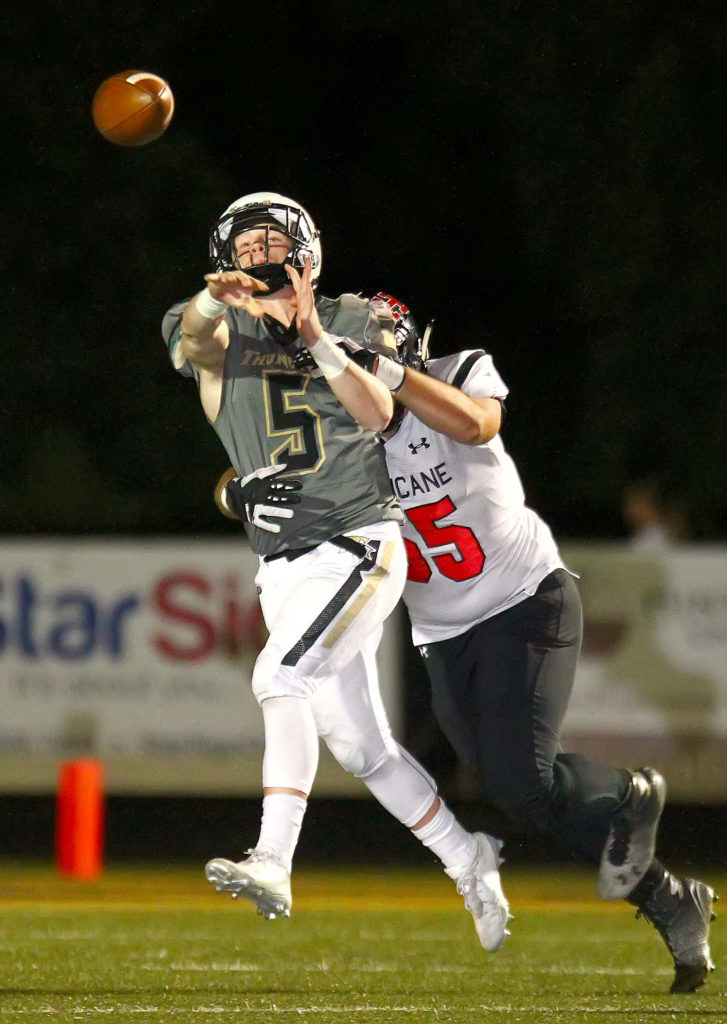 Hurricane's Matthew Lemon (65) puts pressure on Desert Hills’ Quinn Kiser (5), Desert Hills vs. Hurricane, Football, St. George, Utah, Sept. 23, 2016, | Photo by Robert Hoppie, ASPpix.com, St. George News